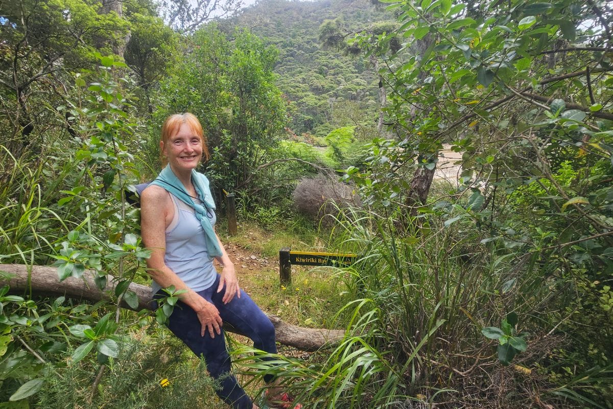 Sandra at the intersection for the Kaiarara track, take the left turn