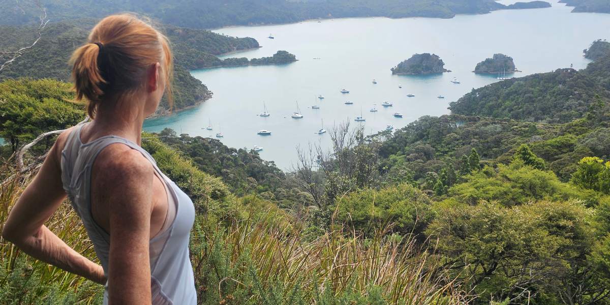 Sandra looking down at the boats in Kiwiriki Bay from the lookout